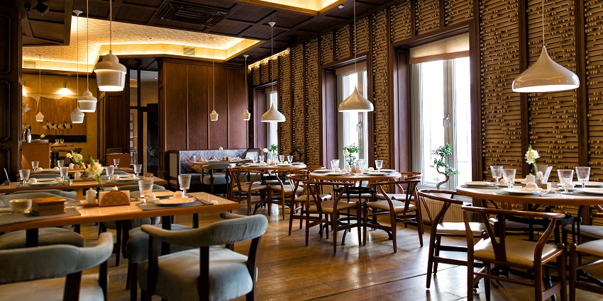 Dining tables inside the Hatfield and McCoy Dinner Feud restaurant with rustic decor.
