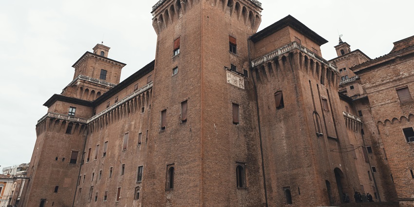 Medieval Castle in Ferrara with towers, moat, and historic brick architecture.