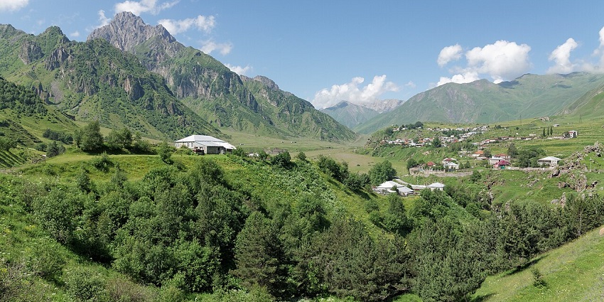 The mountain village of Sioni in Khevi, Georgia, with scattered houses and mountains, one of the places to visit near Turkey.
