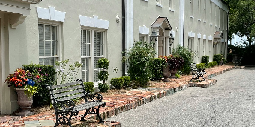 Charming small-town street at dusk with warm lighting, historic buildings, and a peaceful ambiance.