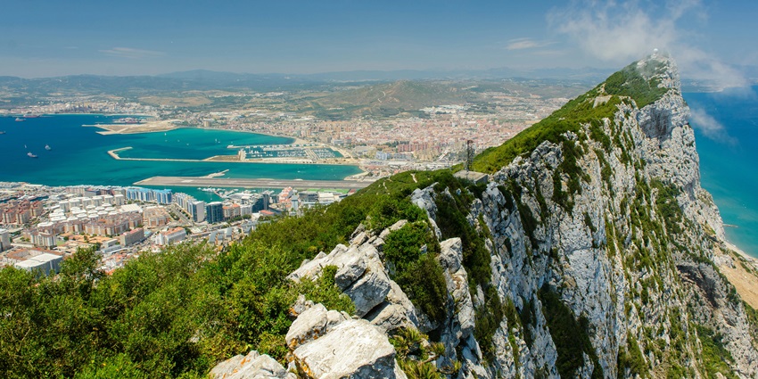 The iconic Rock of Gibraltar rising above the town and harbor on a clear day.