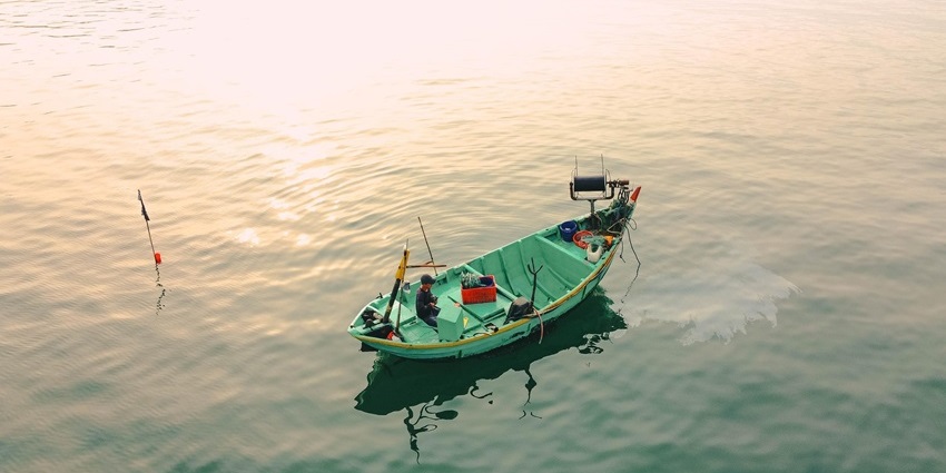A fishing boat on the calm Indian Ocean waters during a deep-sea fishing trip.
