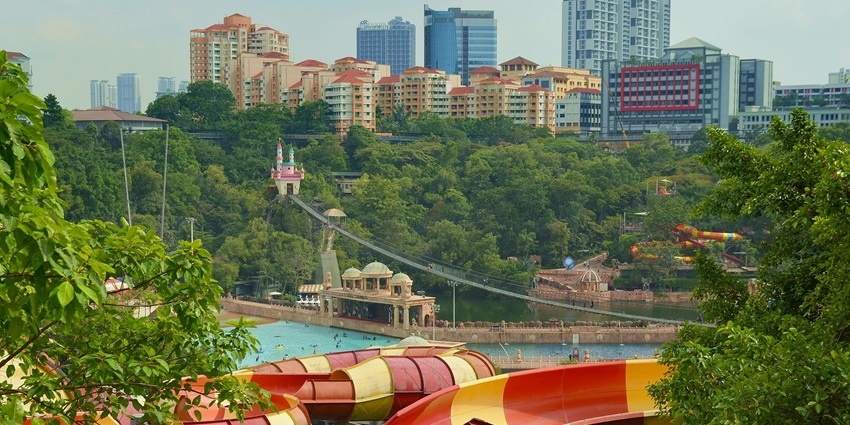 Aerial view of Sunway Lagoon showing colourful water slides, pools, and surrounding trees.