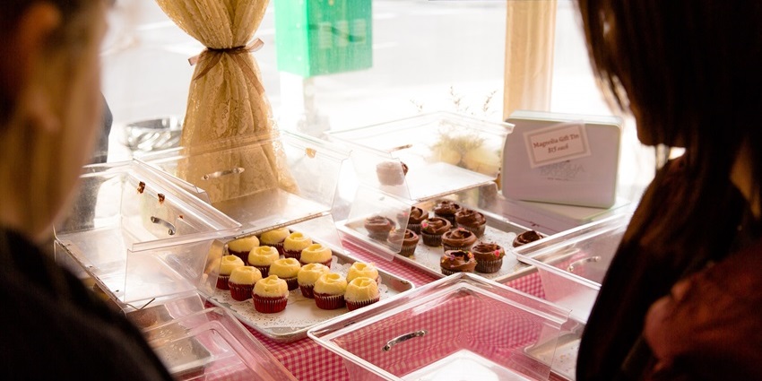 Bakery storefront in Berlin, Germany, displaying croissants, bread, and other baked goods.