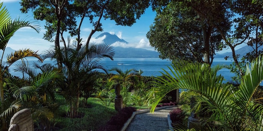 Peaceful view of Lake Atitlán surrounded by volcanoes, one of the stunning places to visit near Mexico.