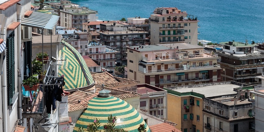 View Maiori’s tiled church domes, hillside homes, and a sea from the lemon trail path, one of the things to do in Maiori.