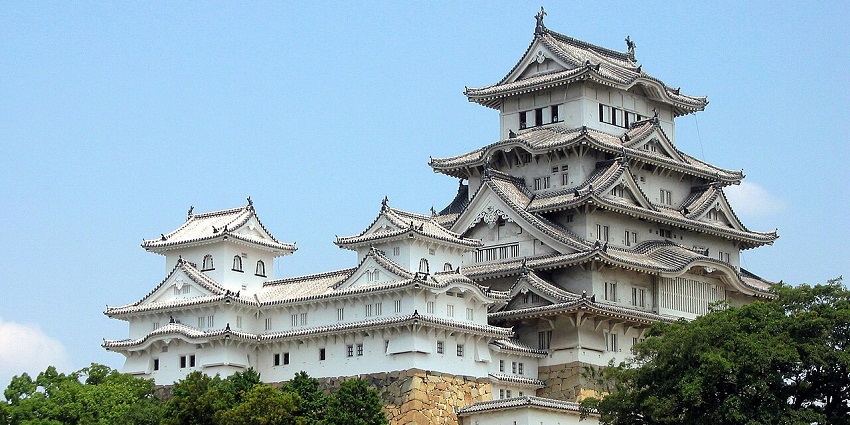 The white traditional Himeji Castle amid greenery, among the top places to visit near Osaka.
