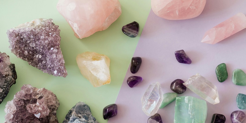 A collection of assorted colourful rocks and crystals displayed on a flat surface.