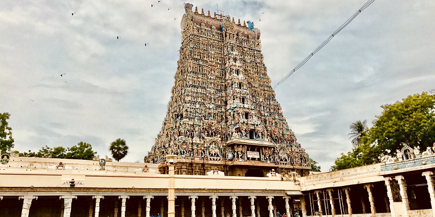 Meenakshi Amman Temple in India with colorful towers and intricate architectural details.