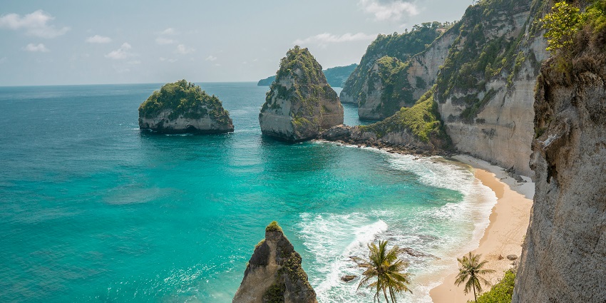 Cliffside view of Nusa Penida with turquoise ocean and dramatic coastal landscape in Bali.