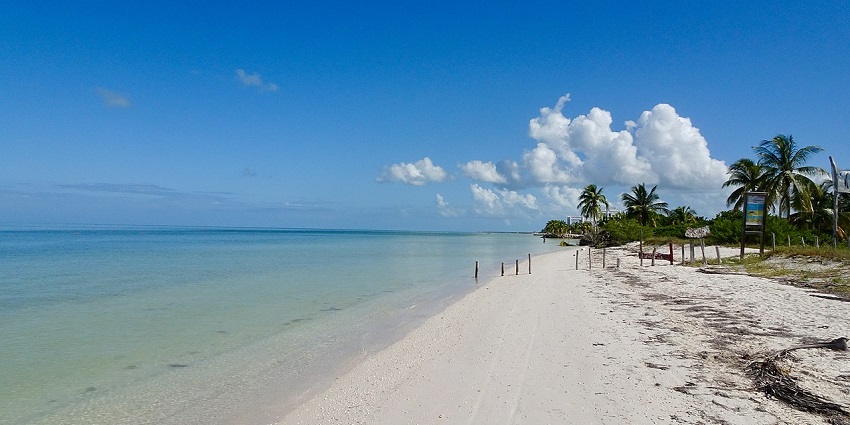 Isla Holbox shows calm, shallow waters, a sandy shoreline, one of the places to visit near Cancun.
