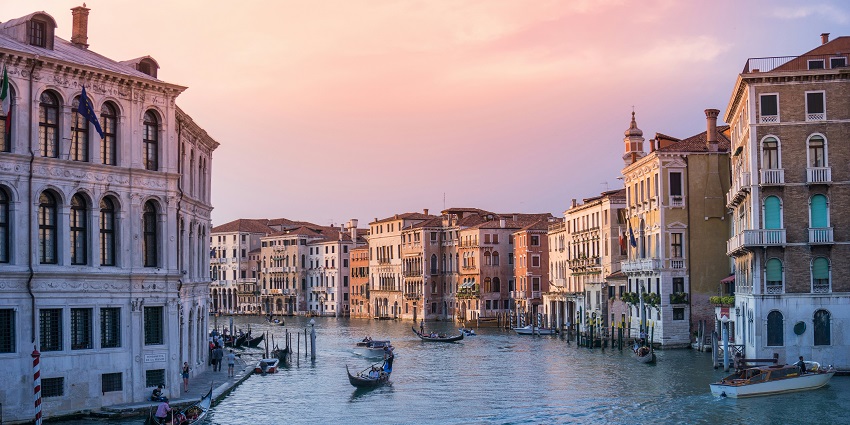 The iconic Rialto Bridge in Venice, Italy, is a charming highlight among places to visit near Switzerland.
