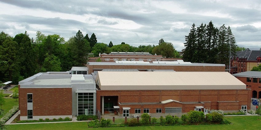 Oregon rec center from above with the red architectural building of the center and green trees.