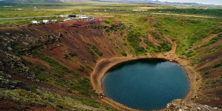 Kerið Crater Lake is a striking volcanic crater filled with vivid blue-green water.