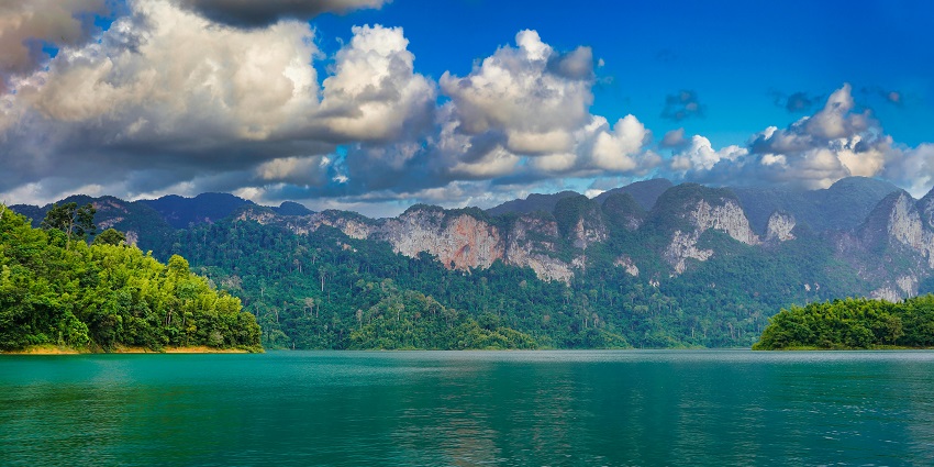 Khao Sok National Park in Thailand, with mountains at a distance and dense greenery.