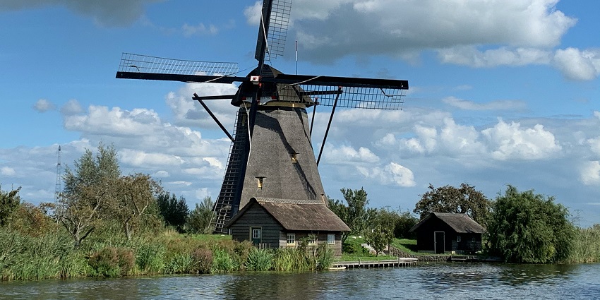 Iconic Kinderdijk windmills by the water, one of the top places to visit near Rotterdam.