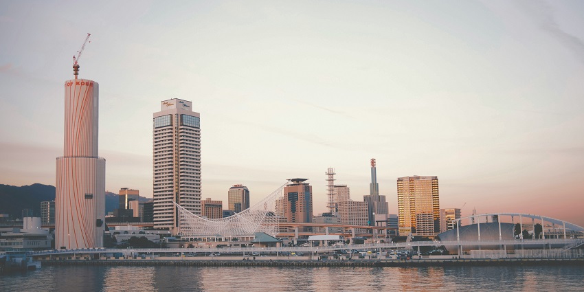 Kobe cityscape featuring waterfront tower, tall buildings, and modern architecture.