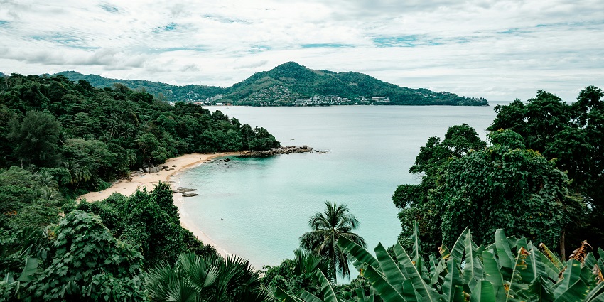 Koh Madsum island beach with clear water and sandy shore in Thailand.