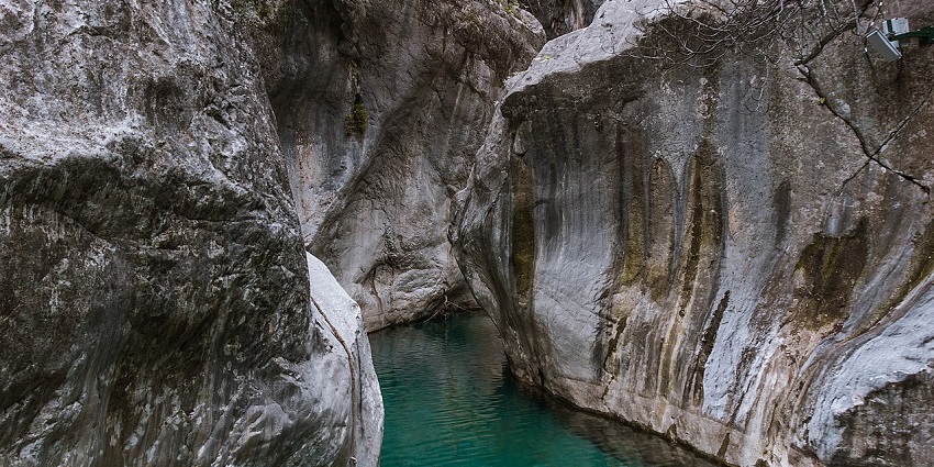 The turquoise river winds through steep, forested cliffs in Köprülü Canyon National Park.