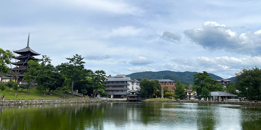 Calm waters of Lake Biwa surrounded by hills and greenery, a scenic spot near Osaka.