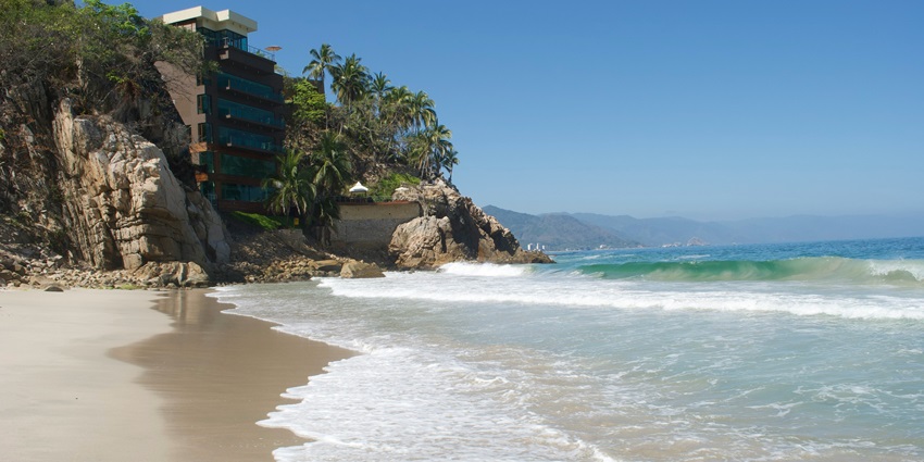 Las Caletas secluded beach with lush greenery and calm turquoise waters near Puerto Vallarta.