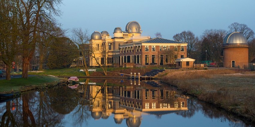 Leiden with a small water body, stairs nearby, and a modern architectural building of an observatory.