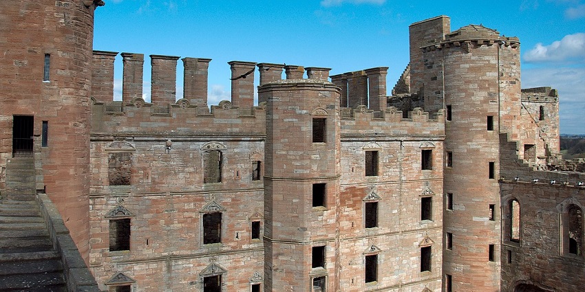 Impressive remains of Linlithgow Palace are reflected in the serene waters of Linlithgow Loch, one of the top places to visit near Edinburgh.