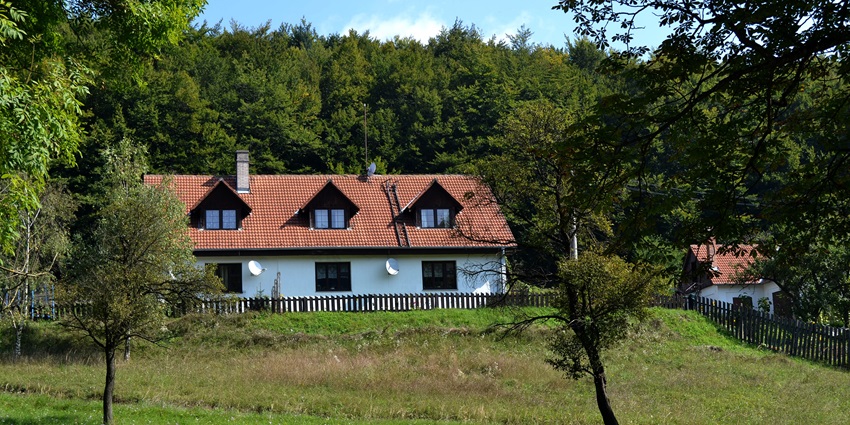 Cosy countryside house with red roof and trees among peaceful places to visit near Bratislava.