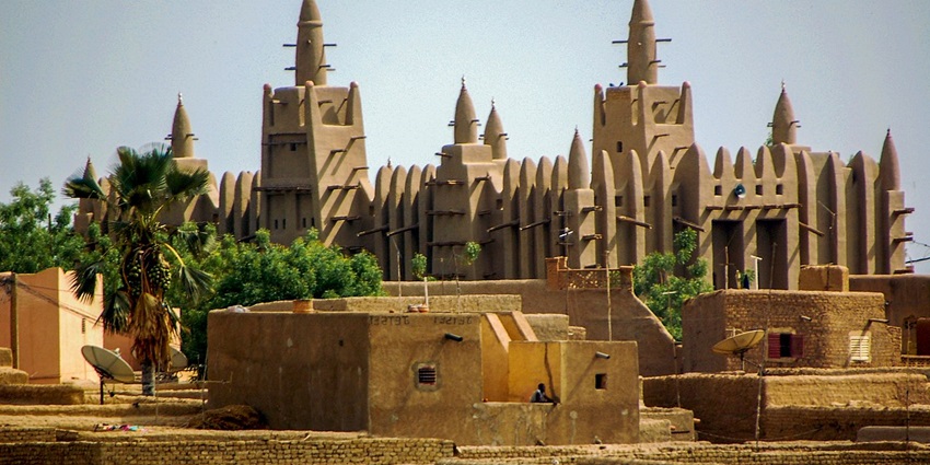 Great Mosque of Djenné in Mali features towering mud-brick walls and wooden support beams.