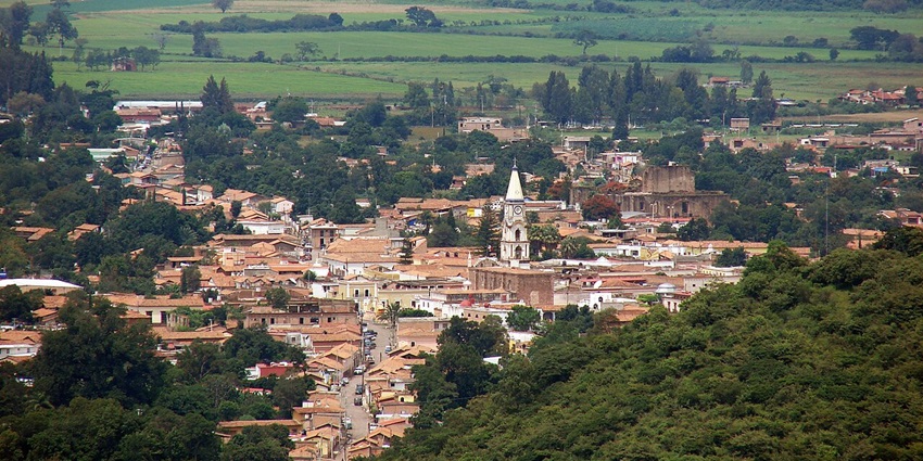 Mascota is far away at a distance, with several buildings and structures among greenery and mountains - places to visit near Puerto Vallarta.