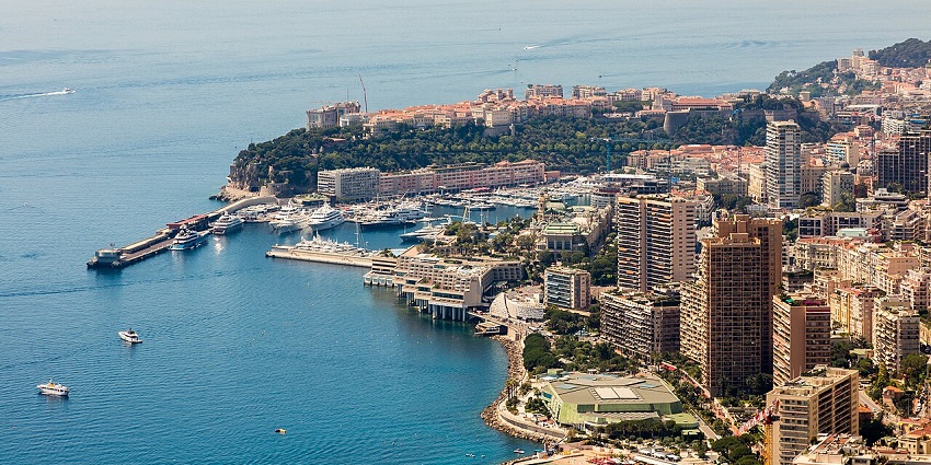 Panoramic view of Monaco’s skyline and Mediterranean coastline from a hillside vantage, among the top places to visit near Italy.