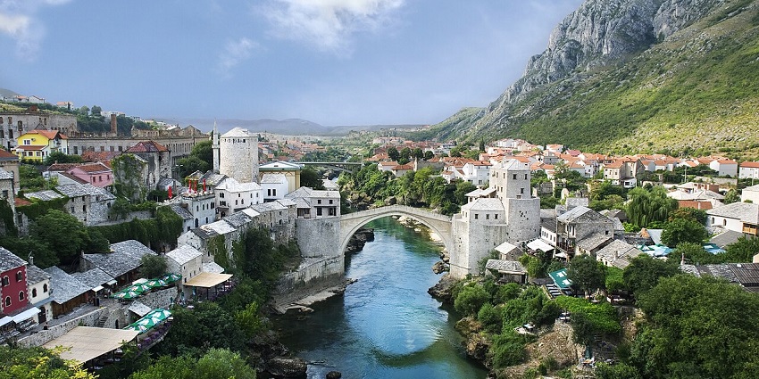 Mostar's old town, with a clear water body of a river and a white architectural bridge, one of the top places to visit near Sarajevo.