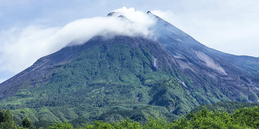 Majestic Mount Merapi with rugged slopes and steaming vents, one of the thrilling places to visit near Yogyakarta.