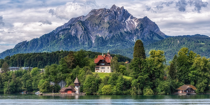Mount Pilatus, with its snow-covered peak, green trees, and lake view, one of the scenic places to visit near Lucerne.