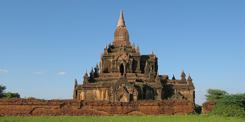 A serene ancient Buddhist temple in Old Bagan, surrounded by greenery, one of the best places to visit near Thailand.

