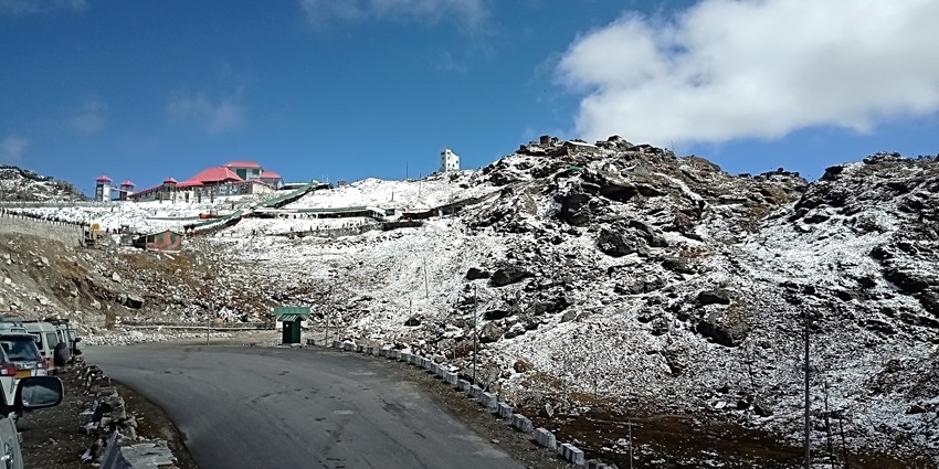 Snow-capped Nathula Pass in Sikkim during October, showcasing clear skies and rugged terrain.