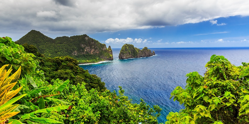 View of Pago Pago harbor with Camel Rock in the background, showcasing natural coastal beauty.