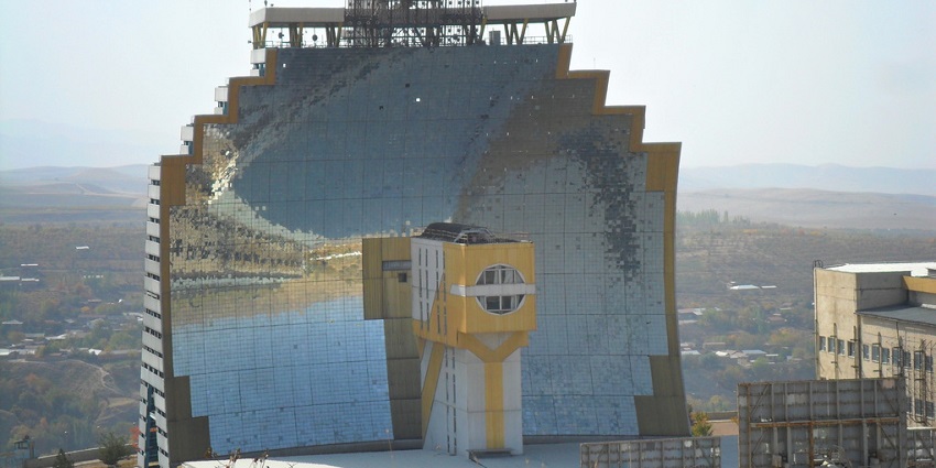 Huge structure of the Parkent solar furnace with its design made of several mirror panels.