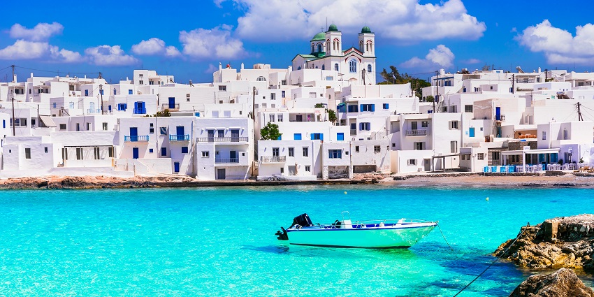 Naoussa village in Paros with white houses and boats, charming places to visit near Santorini.