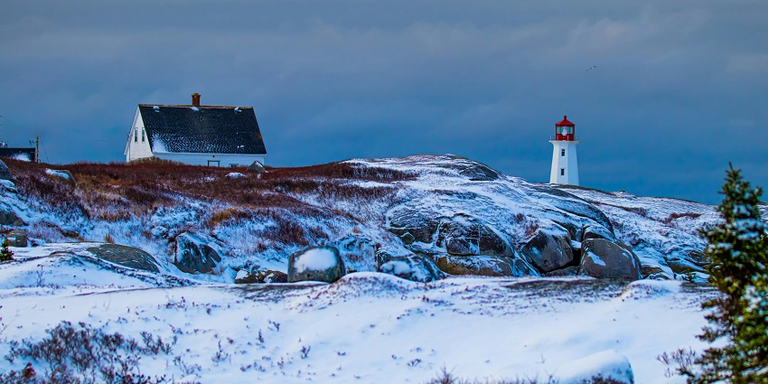 Snowy Peggy’s Cove with the lighthouse, one of the peaceful places to visit near Halifax.