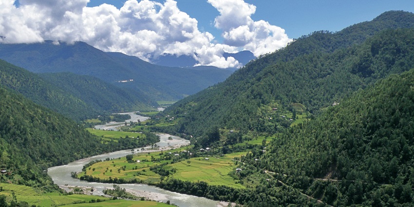 Scenic Phobjikha Valley with green meadows and misty hills, one of the places to visit near Thimphu.
