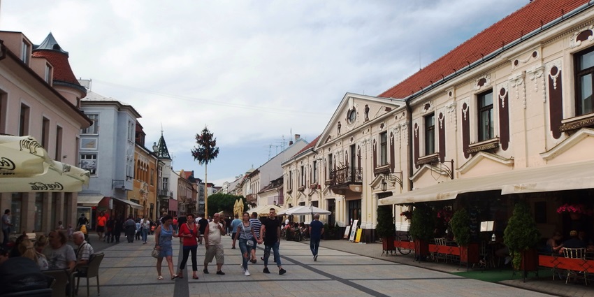 Charming European pedestrian street with cafés and historic buildings among places to visit near Bratislava.