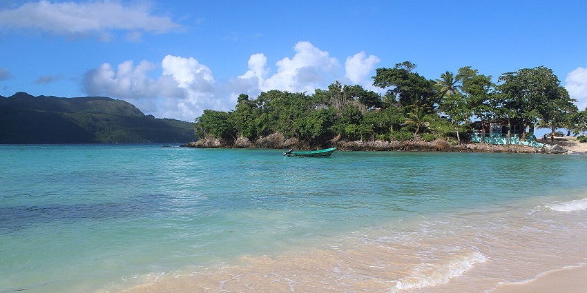 Playa Rincón, a paradise among beaches in the Dominican Republic, with clear blue waters and dense trees.