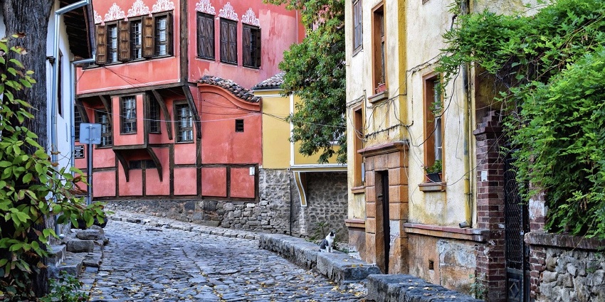 Cobbled street in Plovdiv old town lined with colorful historic houses.