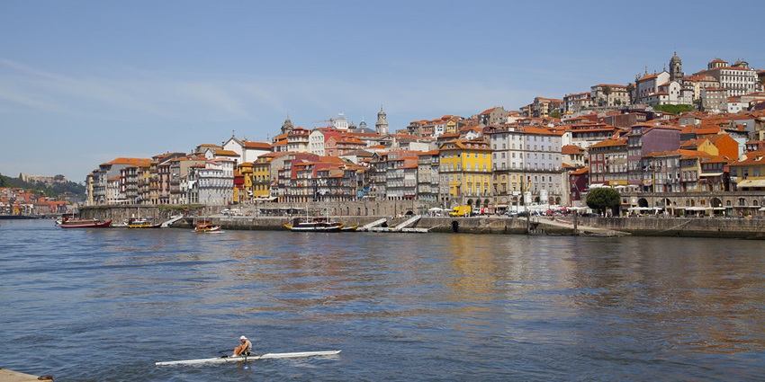 Colourful riverside buildings at Cais da Ribeira in Porto, Portugal, along the Douro River.