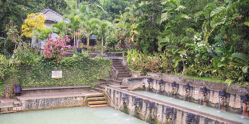 Warm, tiered stone pools surrounded by lush greenery at Banjar Hot Springs, Bali.