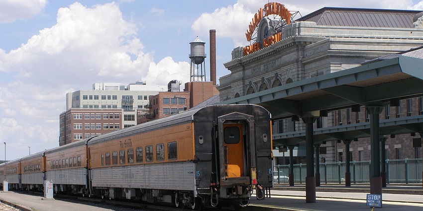 Ski Train on railway tracks under a blue sky, with a station building visible on the back.