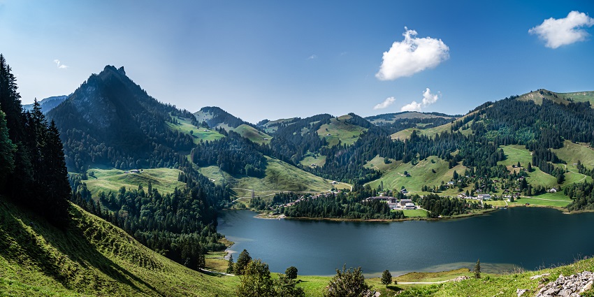 Scenic view of Schwarzsee with calm waters surrounded by alpine landscape and mountain peaks.