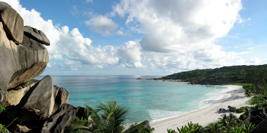 Tropical Grand Anse beach in Seychelles, with palm trees, pristine shore and clear sea, among the best places to visit near Maldives.
