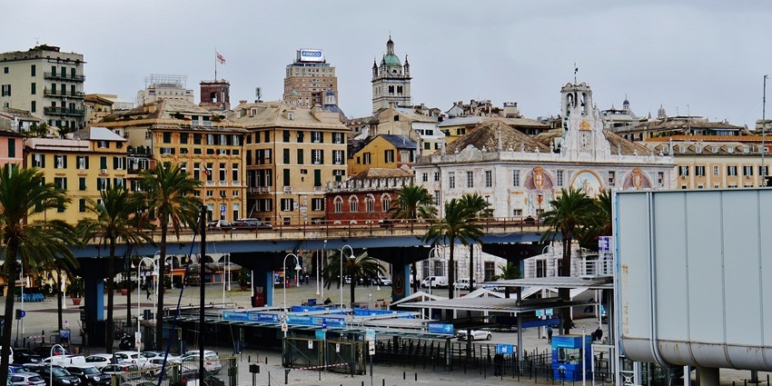 Street view of Via Antonio Gramsci in Genoa, lined with old buildings and busy traffic.